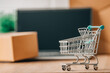 © carballo - shopping cart with laptop and packages, online shopping