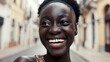 © Babb - Joyful african female young adult smiling on urban street