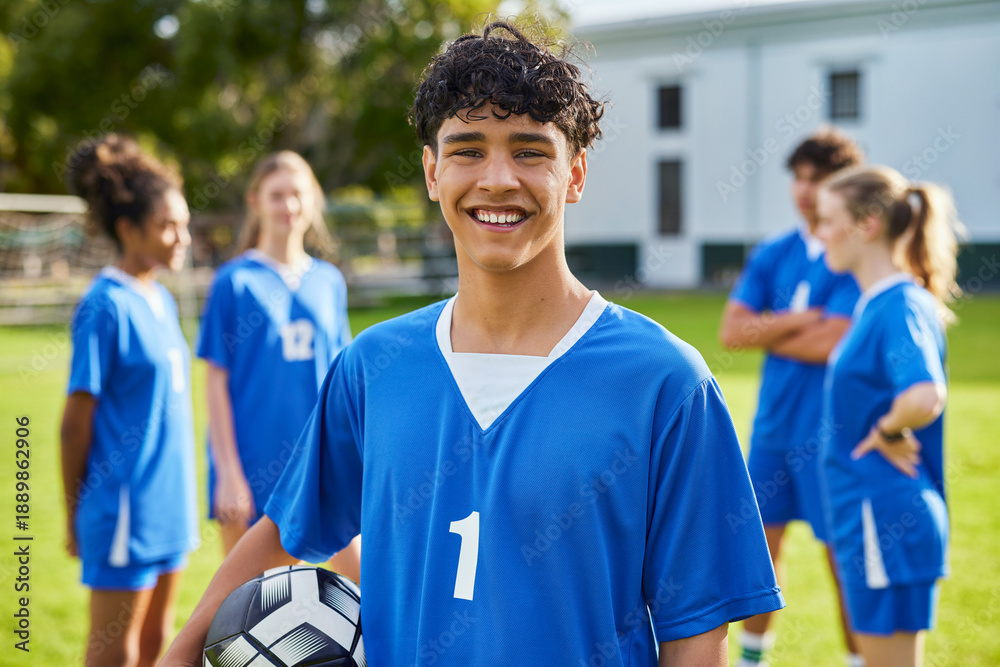 Happy smiling guy holding soccer ball at football field Stock Photo ...