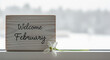 © Tubari - Welcome February wooden sign with white flower minimalist new month greeting home decor