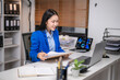 © Wasana - Professional woman working in modern office setting