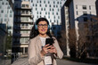 © ADDICTIVE STOCK - Businesswoman enjoying music during a winter workday