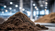 © Laura - Close-up of pile of organic compost material inside large indoor facility, rich textures of decomposing plant matter, soft industrial lighting highlighting details, composting