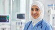 © UnPhouvith - A healthcare professional in a hospital setting, wearing a white hijab and blue scrubs, with a stethoscope around her neck.