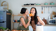 © Stella 16 - Smiling Two young women using electric toaster to make roasted bread for breakfast. Two woman using electric toaster to make roasted bread, addition to a delicious breakfast