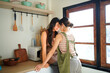 © Stella 16 - Asian women embracing each other in the kitchen. Young women are in a mutual lesbian love relationship