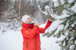 © Katrin_Primak - Smiling woman in snowy forest enjoying winter nature, peaceful outdoor lifestyle concept