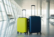 © smth.design - Suitcase luggage standing empty in airport terminal with natural light