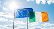 © Mobasser - The European Union and Irish flags waving in the wind on a sunny day with blue sky
