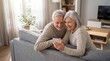 © Starmarpro - Happy senior couple smiling together on couch