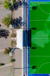 © AmazingAerialAgency - Aerial view of a vibrant green hockey field contrasting with the blue border and the empty parking lot, Mendoza, Argentina.
