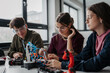 © Halfpoint - High school students working on robotics project as team.