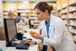© sofiko14 - Pharmacist Working at Computer