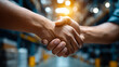 © Nataliya - Warehouse logistics partnership handshake, faceless business gesture, industrial collaboration, supply chain agreement, professional cooperation, defocused facility background, wit