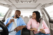© Prostock-studio - Smiling African Amerfican couple fastening seat belts after get in brand new car, happy black lovers having weekend trip together, ready for vacation, driving modern auto, windshield view. Safety Fist