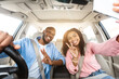© Prostock-studio - Happy black lovers taking selfie while having car trip, sitting in auto, cheerfully smiling at camera, pretty millennial girlfriend and boyfriend showing v victory peace sign gesture, sun flare