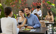 © JackF - Meeting of two married couples in a cozy open-air restaurant