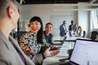 © Marko Geber - Diverse coworkers collaborating during team meeting in modern office