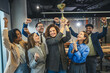 © Miljan Živković - Diverse business team celebrating success winning golden trophy award