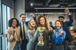 © Miljan Živković - Diverse business team celebrating success winning golden trophy award