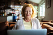 © Geber86 - Smiling senior woman using laptop at home