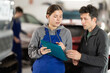 © JackF - Auto repair shop manager discussing with male customer repair and insurance of his car at the auto repair shop