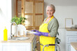 © Pixel-Shot - Mature woman with walker washing dishes in light kitchen