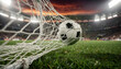© silapin - Action shot of soccer ball hitting the net with flying grass particles and stadium lights background. Goal and victory concept.
