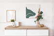 © Pixel-Shot - Home decor and vase of artificial eucalyptus twigs on commode near white wall in living room