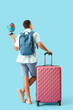 © Pixel-Shot - Male tourist with globe and bags on blue background, back view