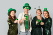 © Pixel-Shot - Group of people with beer on light background. St. Patrick's Day celebration
