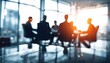 © Thomas - Business people engaged in round table discussion in conference room. Blurred image business partners meeting. Interior setting highlights modern business lifestyle, corporate convention. Focused on