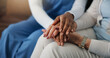 © WesJVR/peopleimages.com - Caregiver, holding hands and people in home with comfort, understanding or empathy in assisted living. Compassion, patient security or nurse with elderly woman, support and trust in retirement care.