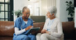 © WesJVR/peopleimages.com - Tablet, nurse and old woman in home for healthcare, homecare and report in retirement. Caregiver, patient and elderly person with technology in house, medical wellness and results in consultation