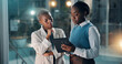 © SparkPix/peopleimages.com - Night, business people and talk in office with tablet, financial review and deadline for company audit. Late, black women and conversation with tech, problem solving and advice for accounting report.