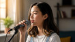 © JunoNaro - young Asian woman singing with microphone