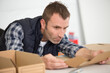 © auremar - portrait of a handsome  man working with card boxes