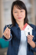 © auremar - young businesswoman real estate agent with hose model and keys