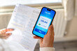 © Tatjana - Managing household expenses and utility bills using mobile banking app at home. Heating and utility expenses concept.