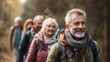 © backup_studio - Elder man hiking with happy group of senior friends in nature, enjoying retirement and healthy active lifestyle
