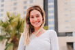 © Jose Calsina - A happy young woman smiling radiantly while embracing the warmth of a sunny day with a joyful demeanor. Her cheerful expression captures the essence of positivity and youthful energy.