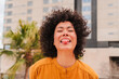 © Jose Calsina - A joyful young woman playfully sticking out her tongue while smiling brightly showcases her cheerful personality and happiness, capturing a moment of carefree fun and spontaneity in an engaging manner