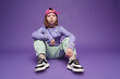 © VISTA by Westend61 - Trendy urban style girl in studio with cap and sneakers