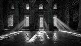 Interior of a stone building with sunlight streaming through doorways and windows