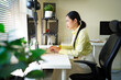 © Stella 16 - a young businesswoman working on a computer in an office. Portrait of an successful young creative businesswoman using PC at her workplace in the modern office
