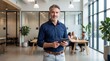 © Muhammad - Smiling Businessman Using Tablet in Modern Office