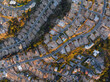 © AmazingAerialAgency - Aerial view of a suburban dreamscape where golden light bathes houses nestled along winding roads, casting deep shadows, Los Angeles, California, United States.