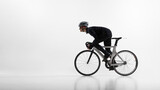Athletic cyclist in aerodynamic position riding road bicycle isolated on white. Concept of speed optimization, racing posture, professional training, competitive sport preparation.