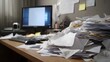 © Bussakon - A busy cluttered office desk overflowing with stacks of paper documents and computer equipment reflecting a state of disorganization