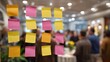 © Bussakon - Colorful sticky notes are arranged on a glass surface in a blurred background of a business meeting